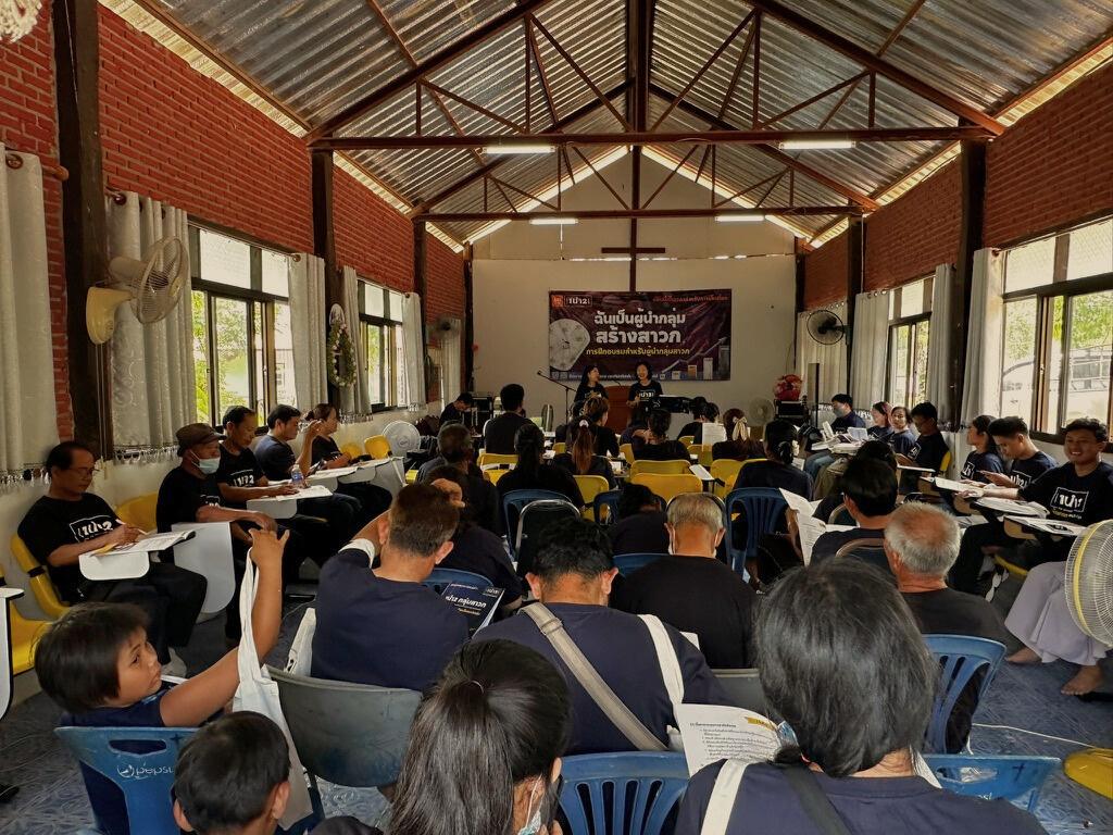 Church members gathered for 1นำ2 training in a village church hall